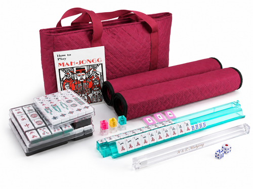 Close-up of burgundy-case Mahjong set with white tiles and teal rack-pusher